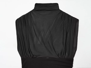 Detailed view of black mesh dress showing mock neck design and pleated fabric texture