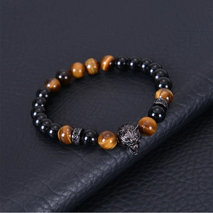 Detailed shot of 8mm tiger eye stone bracelet with black wolf head and zircon spacer