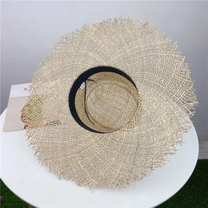 Handwoven straw hat with frayed edges and hollow design for sun protection