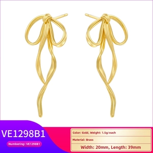 Detail view of gold brass bow ribbon earrings with dimensions 20mm by 39mm