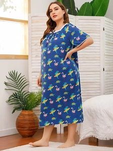 Detail of plus size nightgown featuring flamingo prints and white lace trim on sleeves