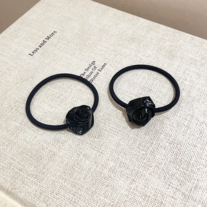Pair of black rose flower hair ties with elastic bands for ballet style hair styling