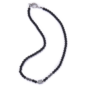 Close-up of 6mm black stone beads necklace featuring a metal square pendant and OT clasp