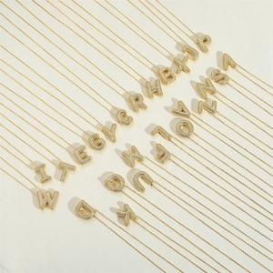 Golden bubble letter pendant necklace set with crystal pavé and elegant cable chain