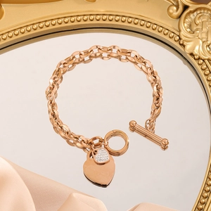 Rose gold stainless steel link bracelet with double heart charms and an OT clasp