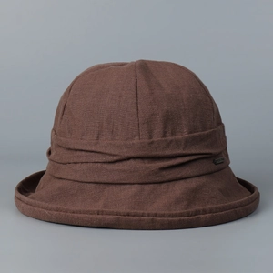 Close-up of the premium brown linen fabric and metal tag on this elegant bucket hat