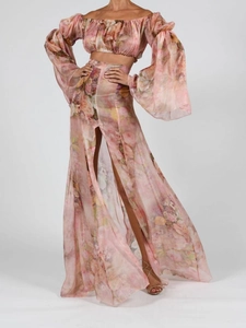Detail of bohemian pink floral crop top and high slit maxi skirt in lightweight fabric
