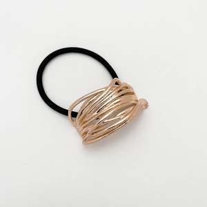 Detail of rose gold wire-wrapped metal ring on black high-elastic seamless hair tie