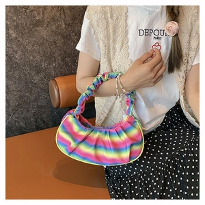 Detailed view of ruched shoulder bag with vibrant rainbow gradient and pleated handle