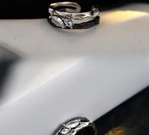 Close-up of gothic two-tone sterling silver ring with marquise-cut zircon stones