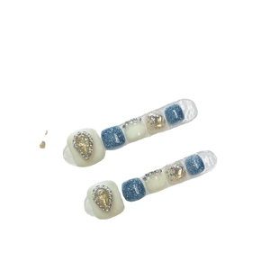 Blue and white handmade toe press-on nails with teardrop gems and glitter accents