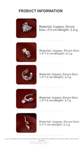 Detailed view of swan and geometric ear cuffs made of copper with sparkling zircon stones