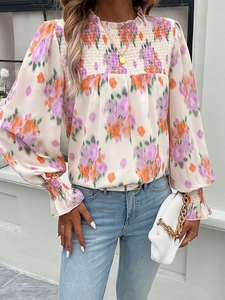 Detail of floral shirt with smocked chest, ruffle high neck and elegant lantern sleeves