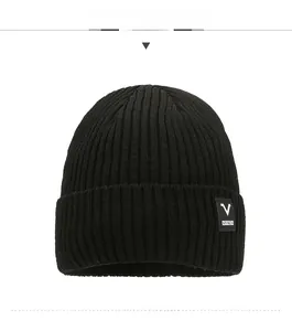 Close-up of black ribbed knit beanie featuring a V SPORTS woven label for outdoor warmth