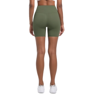 Detail showing V-shaped lifting seams and matte olive green fabric of yoga shorts