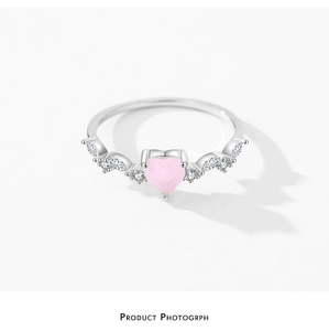 Macro detail of S925 silver heart ring featuring a pink zircon and side stones