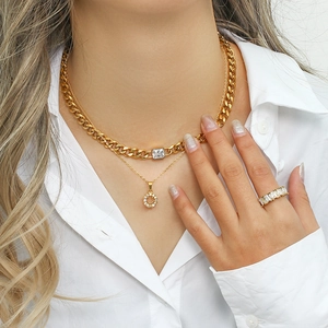 Close-up of a double-layered gold Cuban chain necklace with a square zircon pendant for women