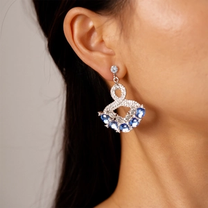 Detail of fan-shaped drop earrings featuring navy blue crystals and micro-pave zircons