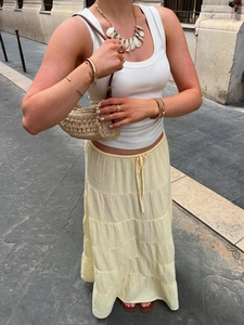 Summer light yellow tiered maxi skirt with layered ruffles and low-waisted bohemian style