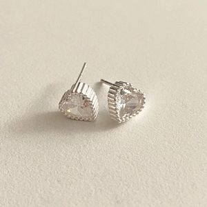 Detail of 925 sterling silver heart earrings with sparkling cubic zirconia and beaded edges
