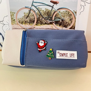 Blue canvas pencil case with Santa Claus and Christmas tree pins in simple life style