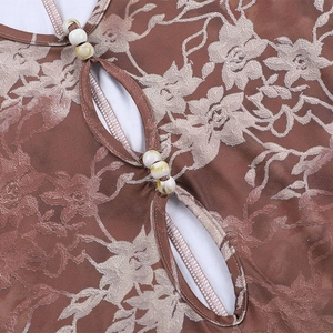 Detail of floral print romper featuring front cut-outs and intricate beadwork accents