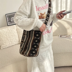 Detail of soft plush shoulder bag with vintage geometric patterns on a lifestyle background