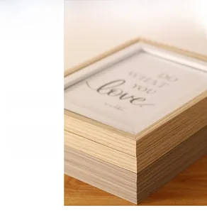 Detail view of double-sided rotating wooden photo frames in light oak and grey-brown finishes