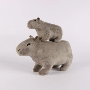 Detailed comparison of large and small plush capybara toys with soft brown fur texture