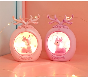 Detail of pink reindeer night lights with glowing warm led lights for cozy bedroom decor
