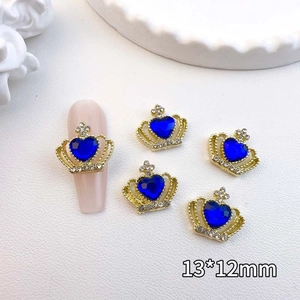 Detail of 13x12mm gold crown nail art charm with blue heart stone and white rhinestones