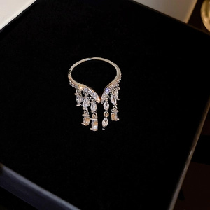Elegant silver tassel ring with sparkling zircon stones on a black velvet background