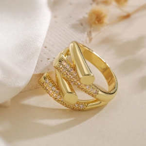 Irregular geometric spiral ring in gold finish featuring clear zircon crystal accents