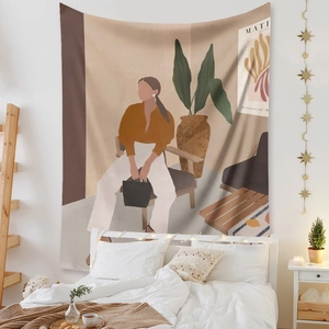 Detail of bohemian tapestry featuring Matisse-style female art on a bedroom wall