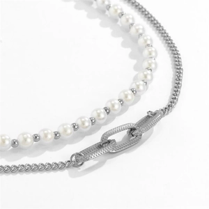 Detail of silver double layer necklace with white pearls and textured metal chain links