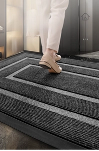 Top view of striped anti-slip rubber door mat used in home entryway for dust removal