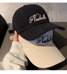 Close-up of Nashville letter embroidery and canvas texture on stylish baseball caps