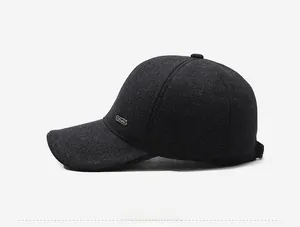 Detail view of winter baseball cap with plush lining, ear flaps and metallic logo accent