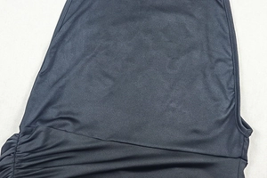 Detail of ruched side design on black slim-fit sleeveless midi dress in silky fabric