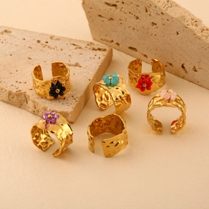 Golden wide band rings with hammered texture and colorful flower charms on stones