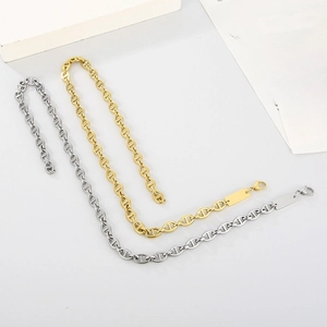 Detail of gold and silver pig nose chain necklaces with blank rectangular pendant
