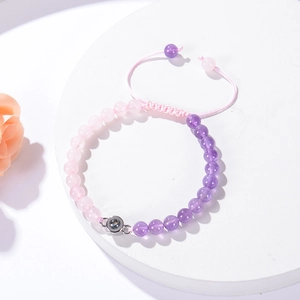Detail of pink zebra stone bracelet with 100 languages I love you projection stone