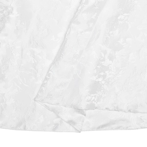 Detailed macro view of white floral jacquard fabric with elegant silk satin finish texture