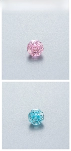 Detailed view of light blue and pink rose cut octagonal crystals with faceted edges