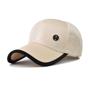 Classic beige baseball cap with brown brim and metal M logo shown from a side view
