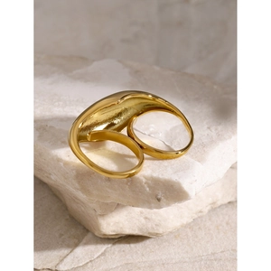 Polished 18k gold plated chunky double-finger ring on a textured stone background