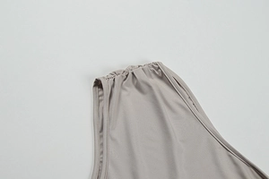 Close-up of the pleated shoulder detail on a slim-fit grey two-piece set for women