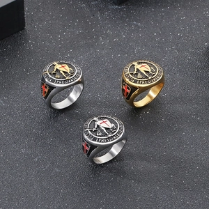 Detail of shield rings with red cross and Bible verse engraving in multiple colors