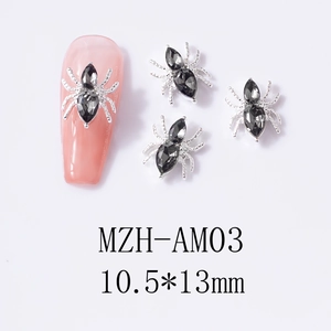 Macro shot of silver alloy spider nail art charms with black crystals and dimensions