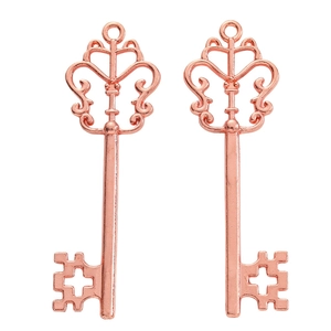 Detailed view of two rose gold alloy key pendants with cross-patterned teeth and top rings